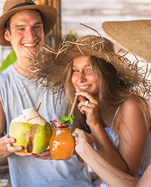 Couple enjoying a coconut and tropical drink